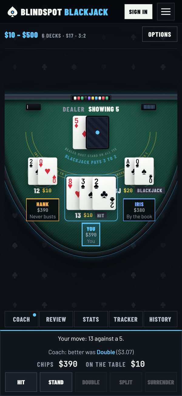 The blackjack table on a phone with the coach's verdict above the buttons